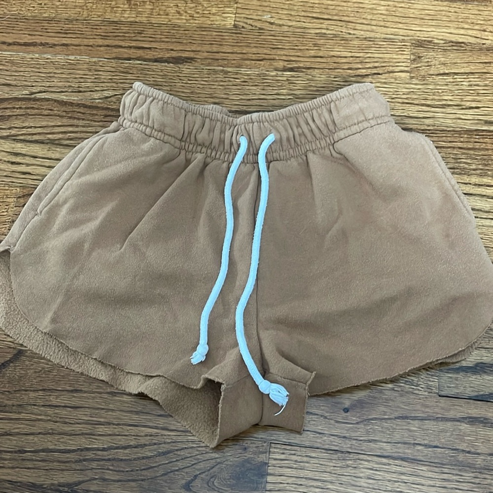 Tan sweat shorts with white tie strings